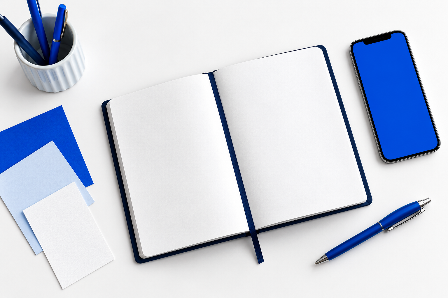 Illustrative blue and white workspace with a notebook and phone